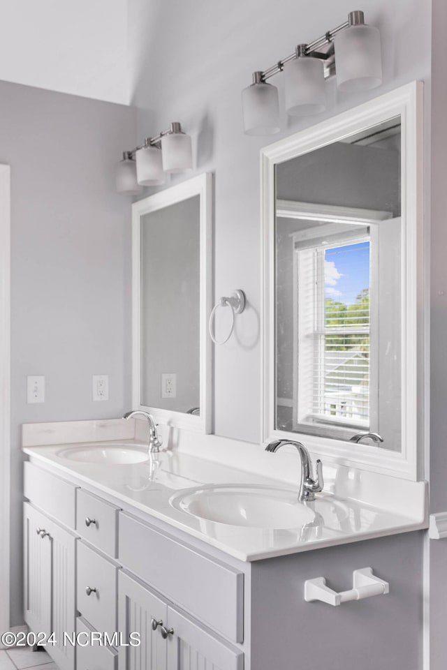 bathroom featuring double vanity and a sink