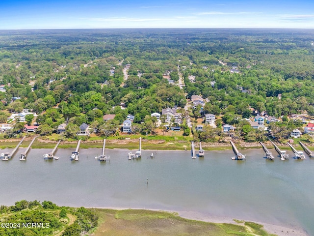 aerial view with a forest view and a water view