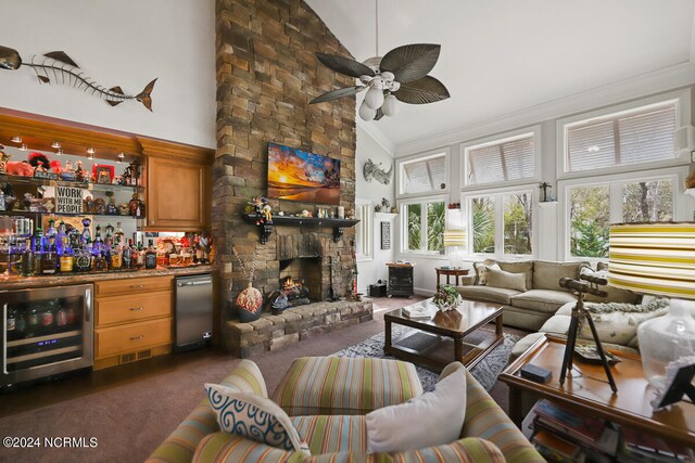 carpeted living room with beverage cooler, high vaulted ceiling, a fireplace, and ceiling fan