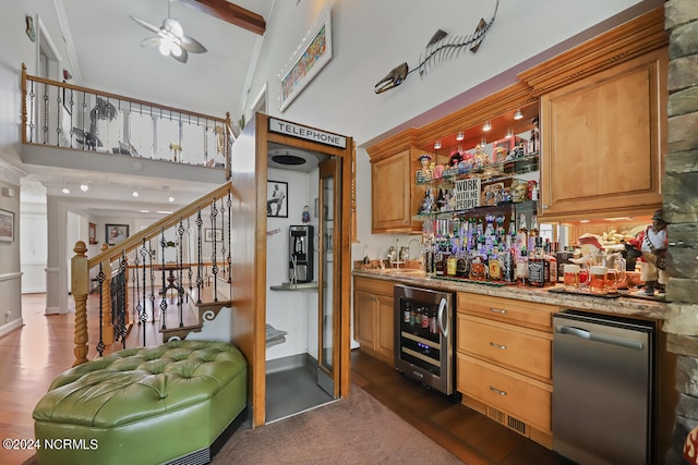 bar with stainless steel dishwasher, dark hardwood / wood-style flooring, light stone counters, wine cooler, and ceiling fan