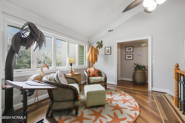 sitting room with ceiling fan, hardwood / wood-style flooring, and lofted ceiling