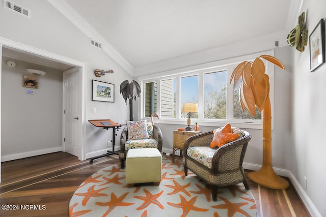 living area featuring crown molding, hardwood / wood-style floors, and lofted ceiling