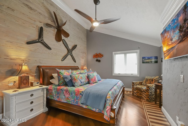 bedroom with hardwood / wood-style floors, lofted ceiling, ceiling fan, and crown molding