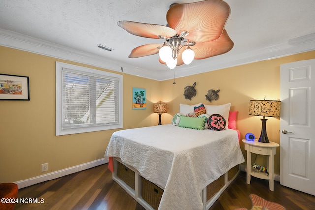 bedroom featuring dark hardwood / wood-style floors, ceiling fan, and crown molding