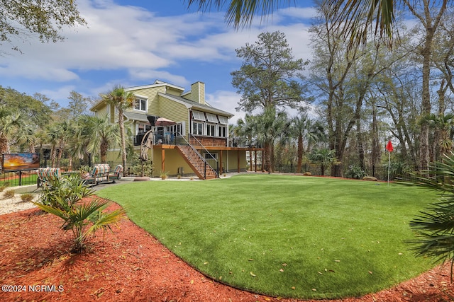 view of yard featuring a deck and a patio area