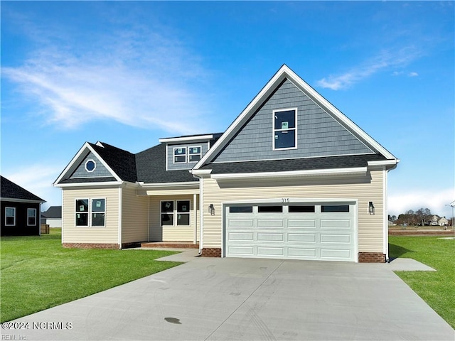 craftsman inspired home featuring a front yard and a garage