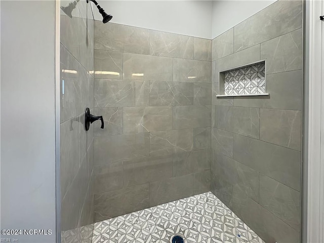 bathroom with tiled shower