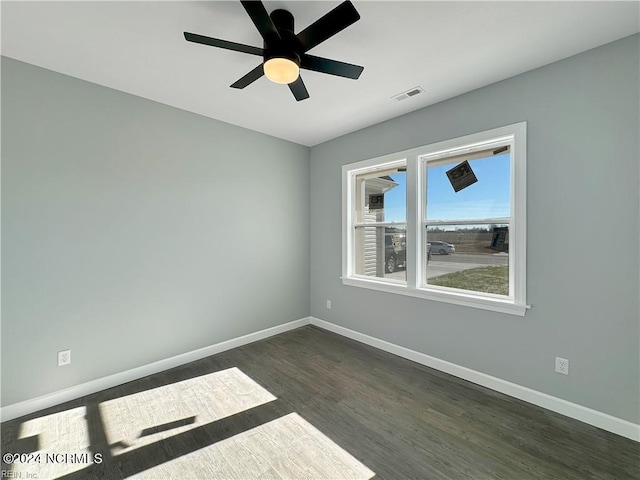 empty room featuring ceiling fan and dark wood-type flooring