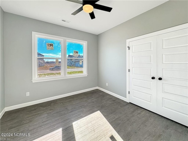 spare room with ceiling fan and dark hardwood / wood-style floors