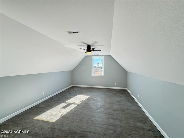 additional living space featuring lofted ceiling, dark hardwood / wood-style floors, and ceiling fan