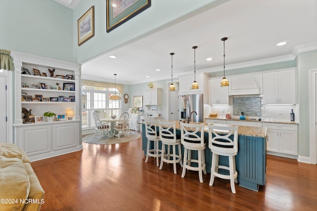 kitchen featuring hanging light fixtures, dark wood-type flooring, and white cabinetry