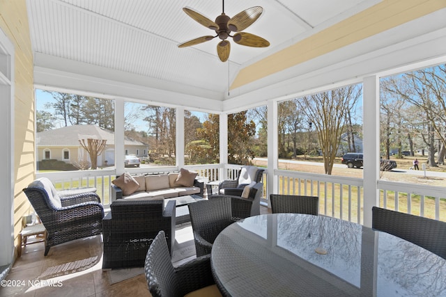 sunroom / solarium featuring ceiling fan and lofted ceiling