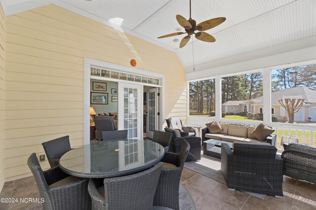 sunroom with french doors, vaulted ceiling, and ceiling fan