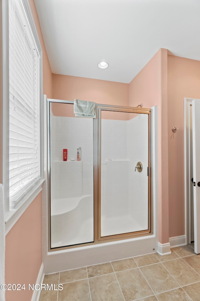 bathroom with tile floors and an enclosed shower