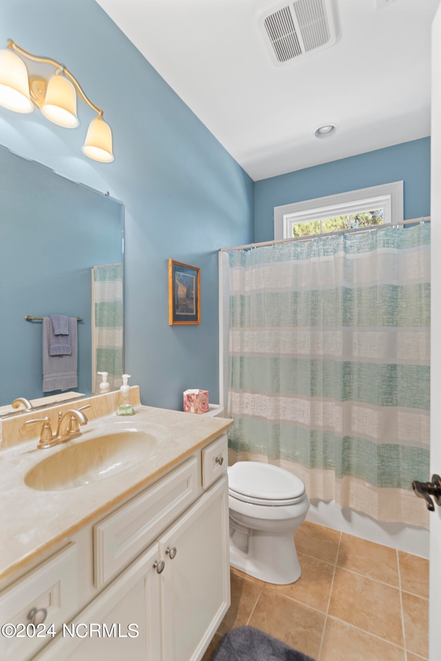 bathroom with oversized vanity, toilet, and tile floors