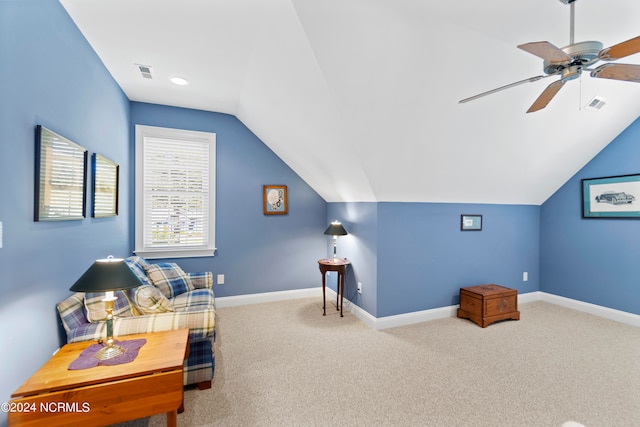 living area featuring light carpet, lofted ceiling, and ceiling fan