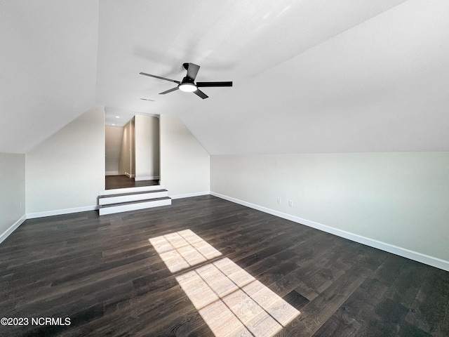 bonus room featuring ceiling fan, dark wood-type flooring, and lofted ceiling