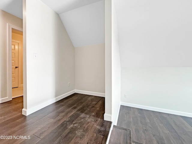 additional living space with lofted ceiling and dark hardwood / wood-style floors