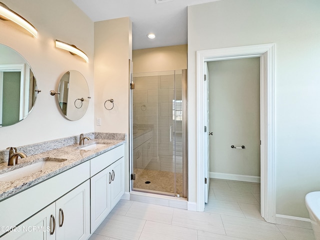 bathroom with an enclosed shower, double sink vanity, and tile flooring