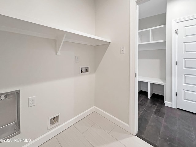 laundry room with hookup for a washing machine and light tile flooring