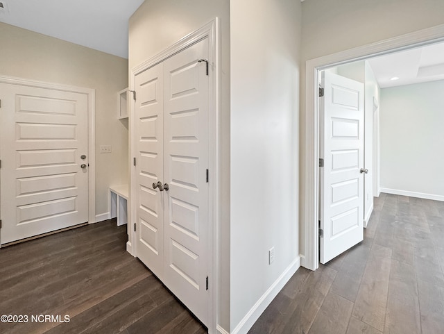 hall with dark hardwood / wood-style floors