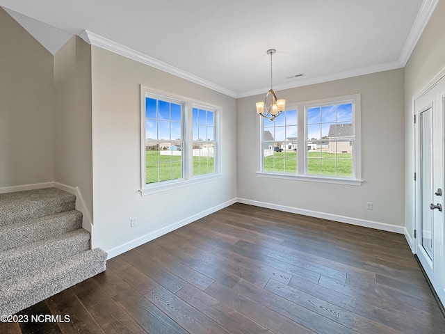 unfurnished dining area featuring ornamental molding, dark wood-type flooring, and an inviting chandelier