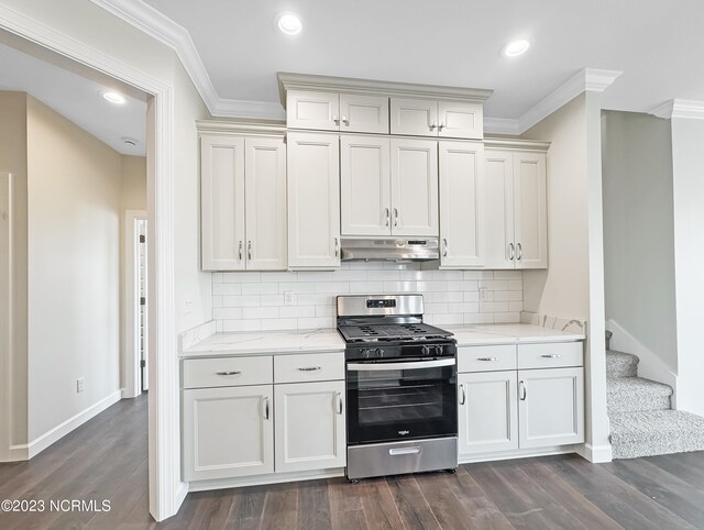 kitchen with crown molding, dark hardwood / wood-style floors, stainless steel gas range, light stone counters, and tasteful backsplash