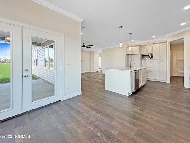 kitchen featuring stainless steel appliances, decorative light fixtures, ceiling fan, backsplash, and dark hardwood / wood-style floors