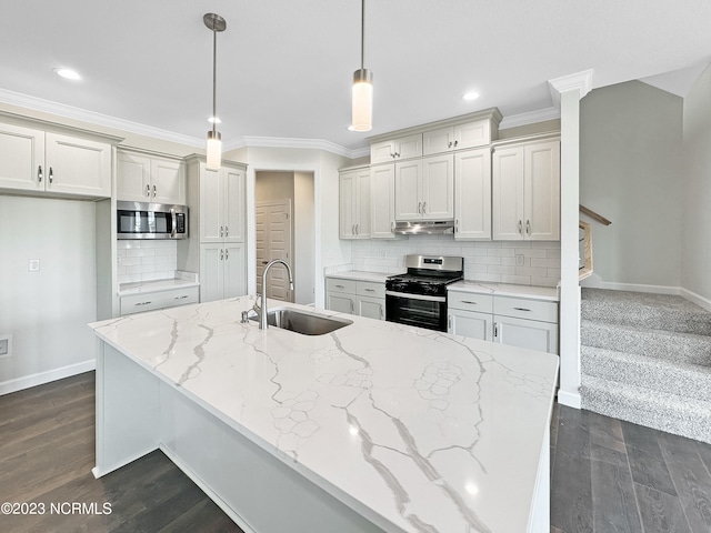 kitchen with appliances with stainless steel finishes, pendant lighting, backsplash, and sink