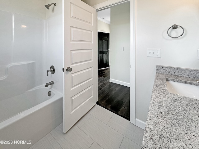 bathroom featuring hardwood / wood-style flooring, bathtub / shower combination, and vanity