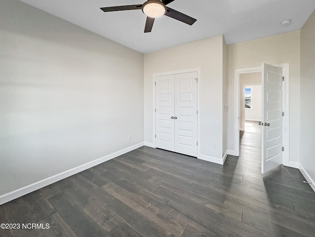 unfurnished bedroom featuring dark hardwood / wood-style floors, a closet, and ceiling fan