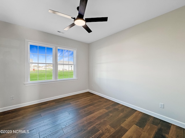 spare room with dark hardwood / wood-style floors and ceiling fan