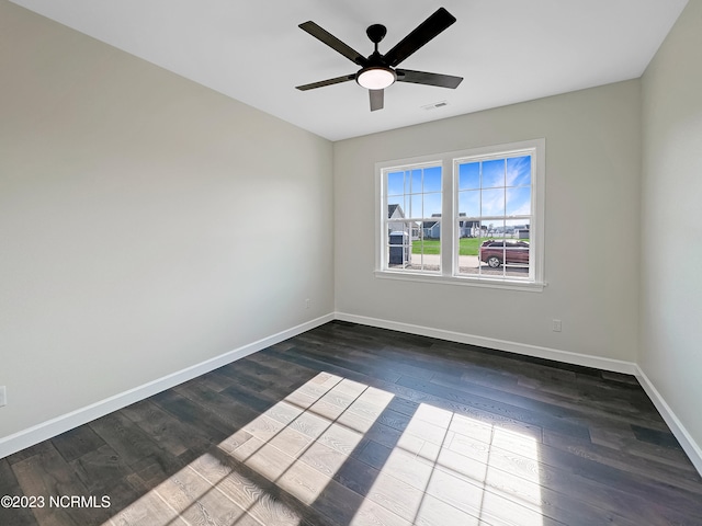 spare room featuring dark hardwood / wood-style floors and ceiling fan