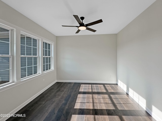 spare room with dark wood-type flooring and ceiling fan