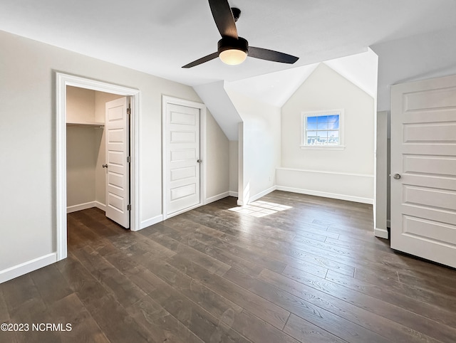 additional living space with ceiling fan, dark wood-type flooring, and lofted ceiling