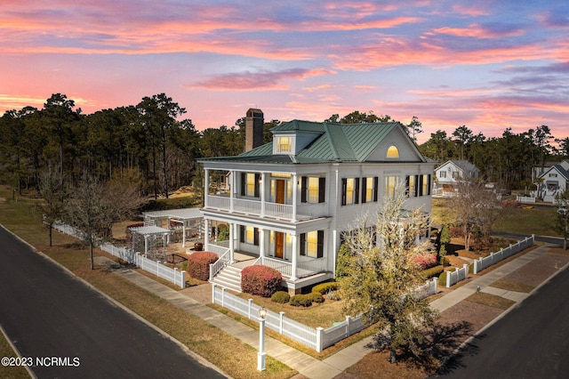 view of front of home featuring a balcony