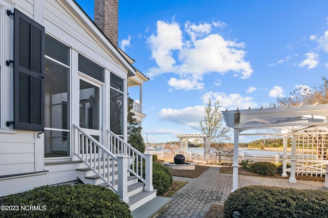 exterior space with a pergola, a patio area, and a sunroom