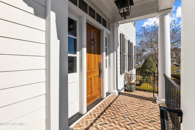 view of exterior entry with a porch