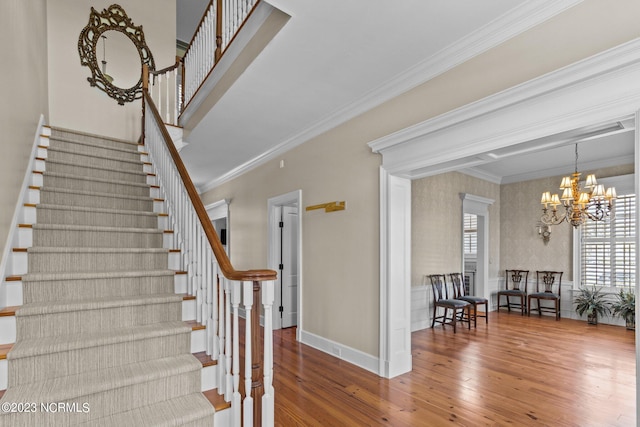 staircase with crown molding, hardwood / wood-style floors, and a wealth of natural light