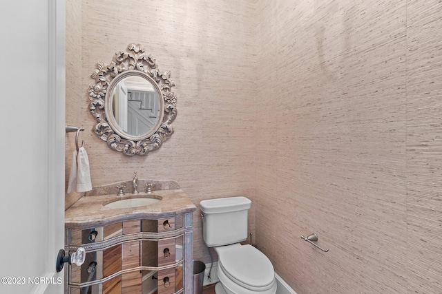 bathroom with toilet and large vanity