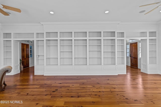 unfurnished room with built in shelves, ceiling fan, and dark hardwood / wood-style flooring