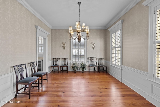 sitting room with a fireplace, ornamental molding, dark hardwood / wood-style floors, and a chandelier