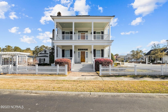 view of front facade with a balcony and a porch