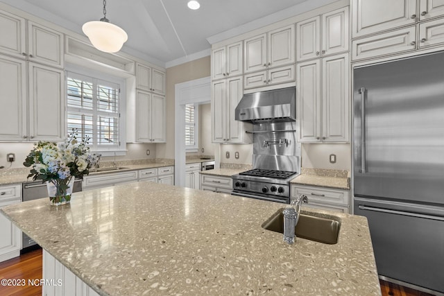 kitchen with pendant lighting, a center island, high end appliances, light stone countertops, and dark hardwood / wood-style floors