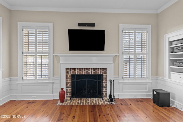 unfurnished living room featuring a wealth of natural light, hardwood / wood-style flooring, and a fireplace