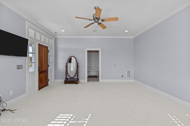 interior space with ornamental molding and ceiling fan