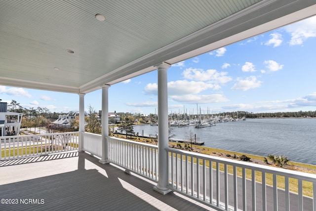 wooden terrace featuring a water view