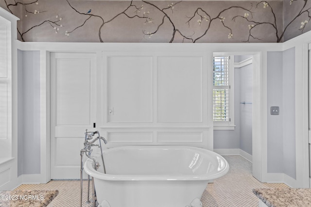 bathroom featuring tile floors and a washtub