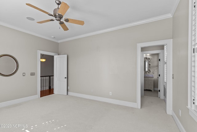 carpeted empty room with ceiling fan and ornamental molding