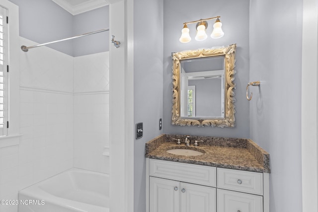 bathroom featuring tiled shower / bath, vanity, and crown molding